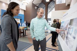 Engagement event attendees looking at a poster board together